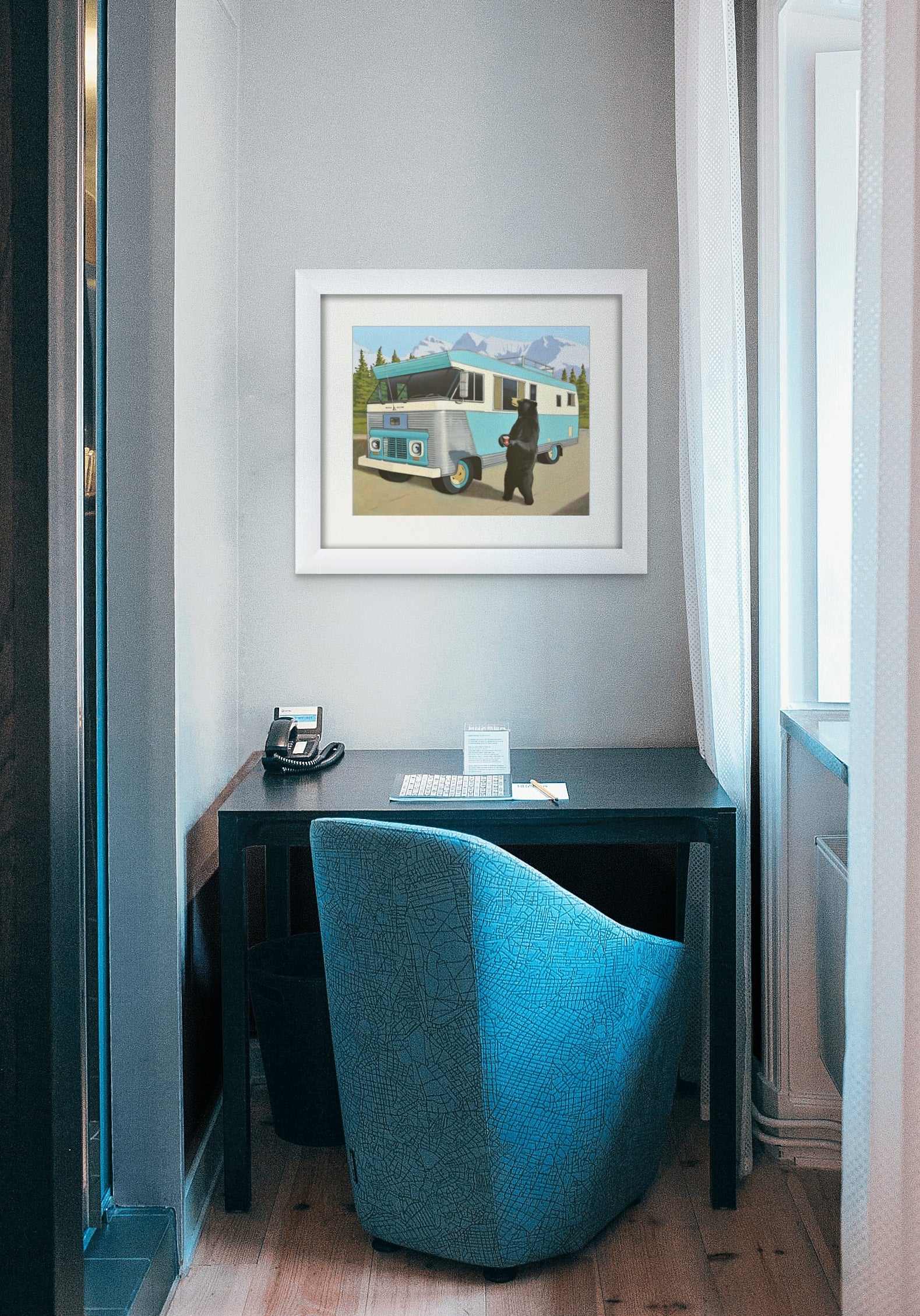 Picture of a Vintage 1963 Condor RV in the Mountains with a Bear Panhandling with a Tim Horton's Cup in Hand framed hanging on wall above a small desk