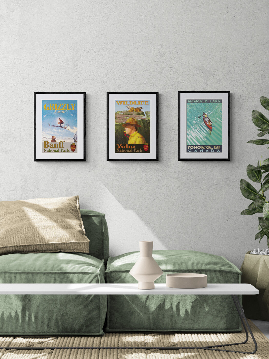 Green sofa in a living room with framed posters on the wall