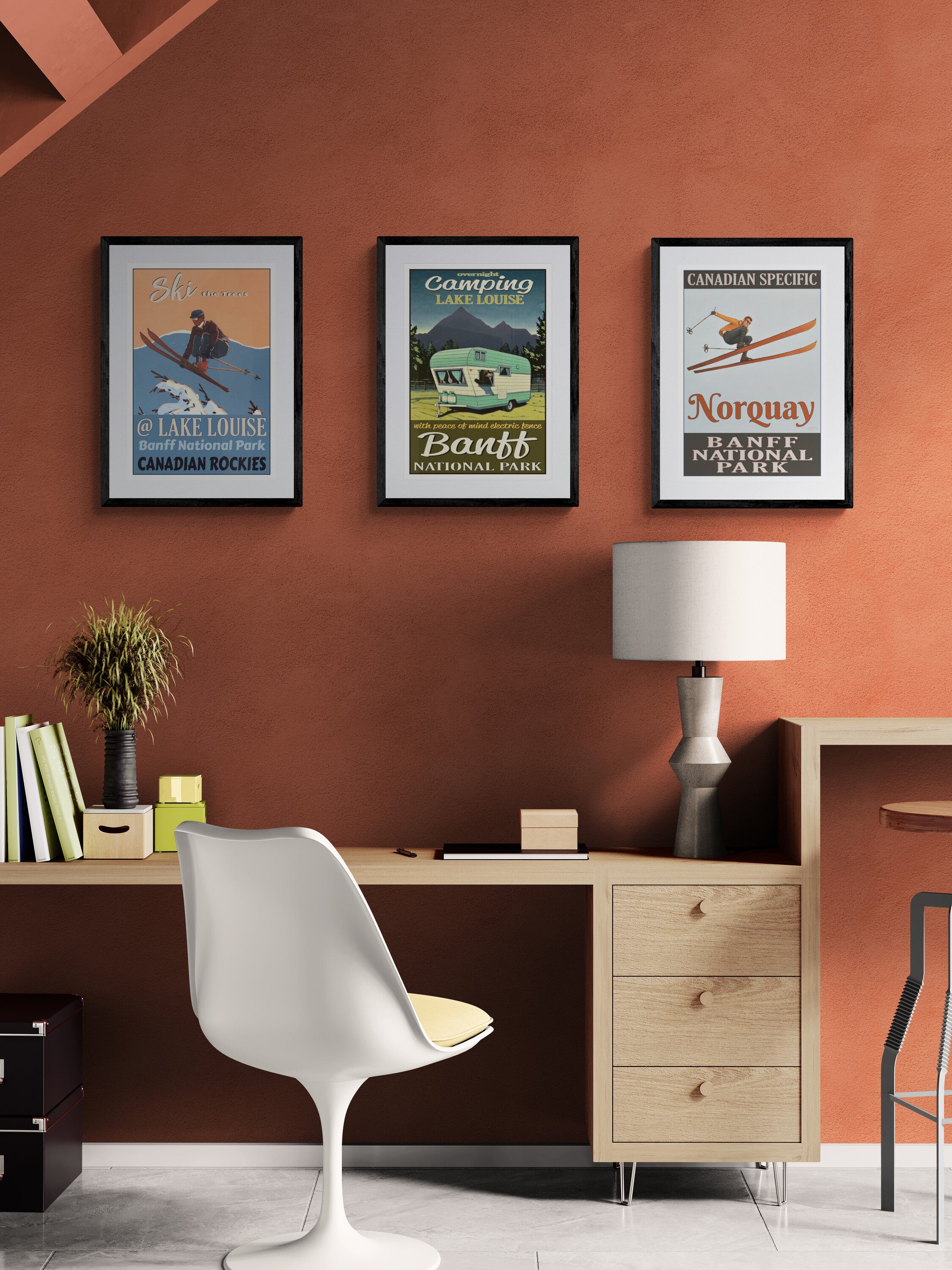 Modern office setup with framed posters on an orange wall