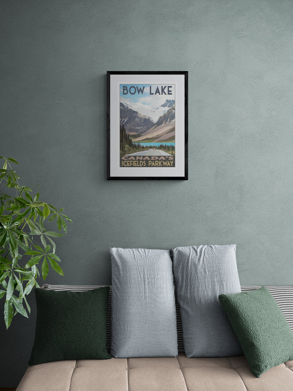 Framed poster of Bow Lake, Alberta on a wall above a sofa with decorative pillows.